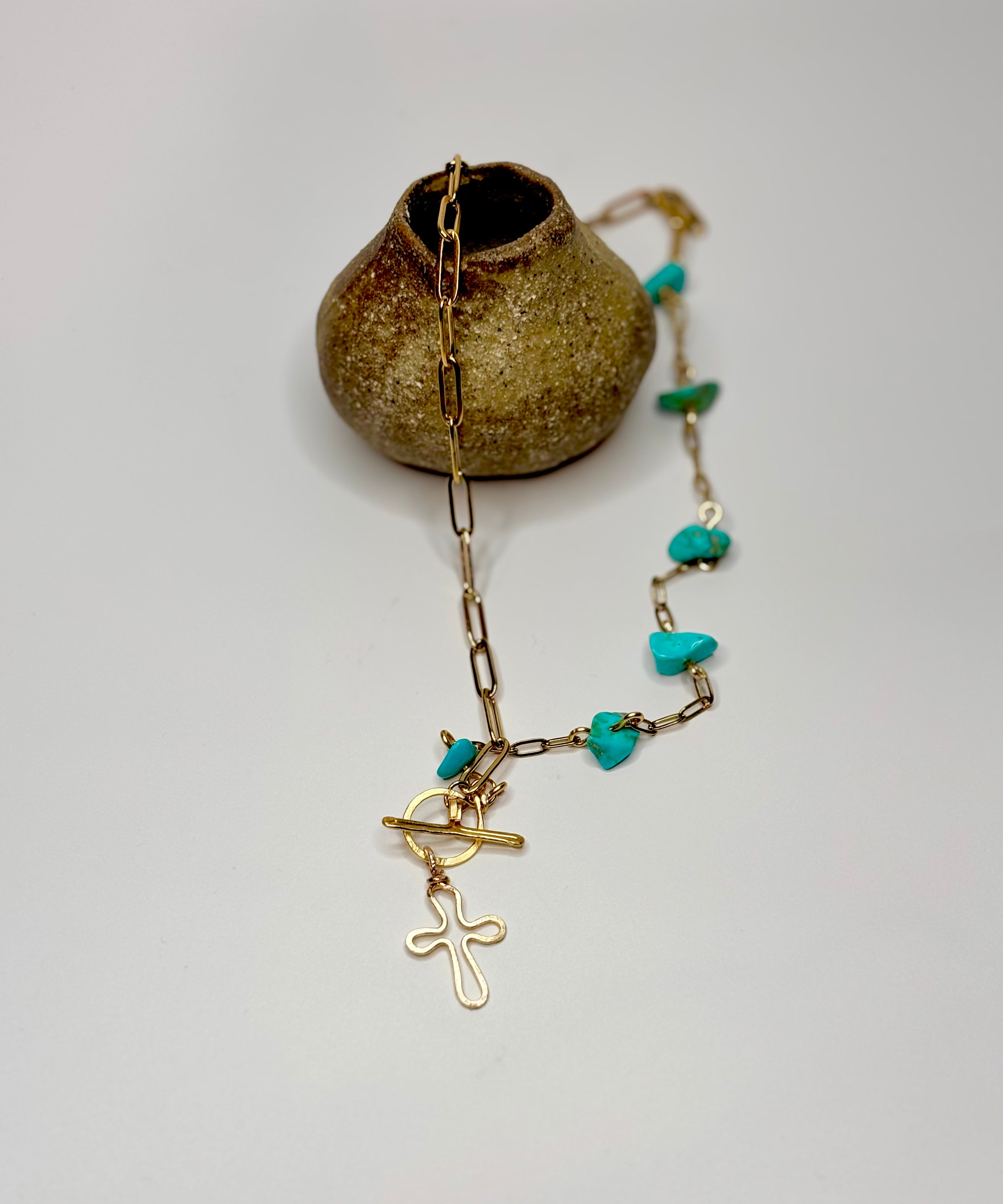 The turquoise cross necklace